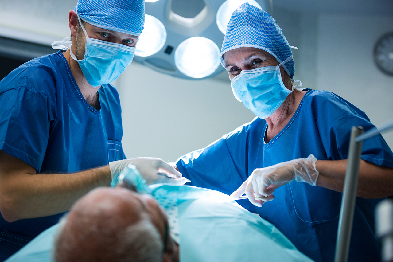 Portrait of surgeons performing operation in operation room